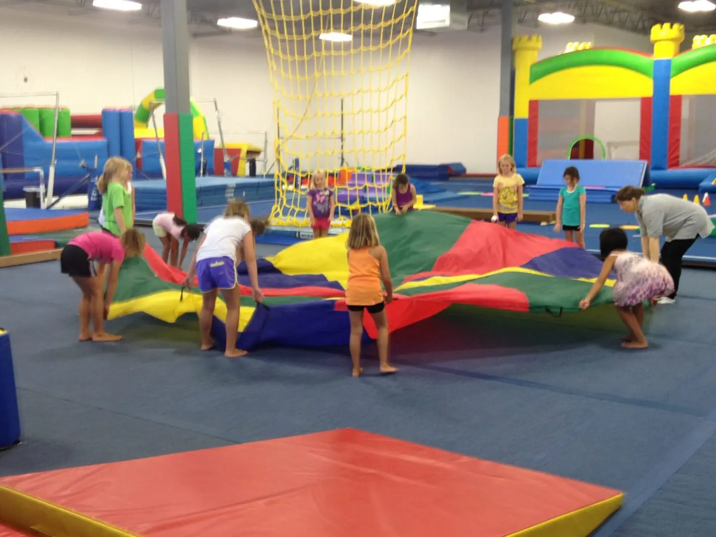 View of the toddlers holding a colorful toy parachute