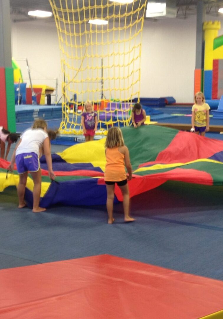 View of the toddlers holding a colorful toy parachute
